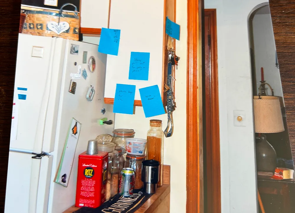 Kitchen counter with jars and sticky notes.