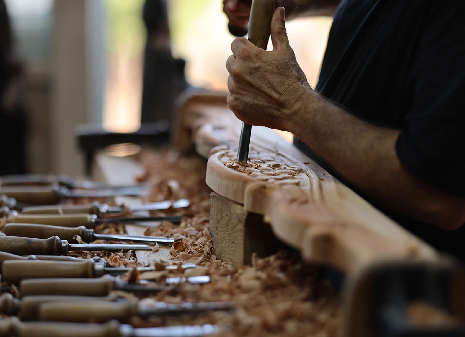 Wood carving in progress with chisels
