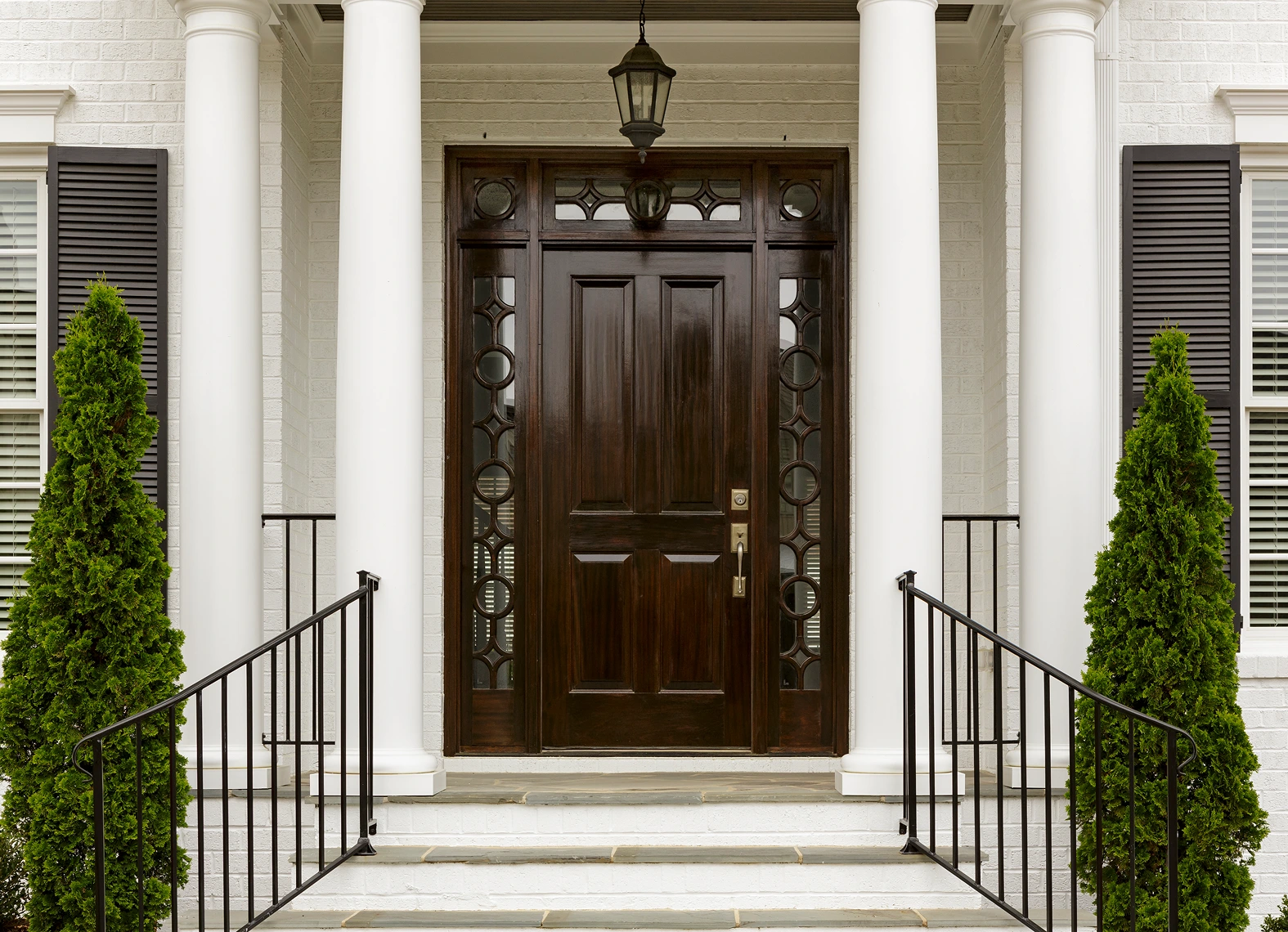 Elegant wooden front door with columns