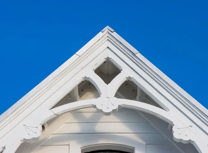 White gable roof against clear blue sky.