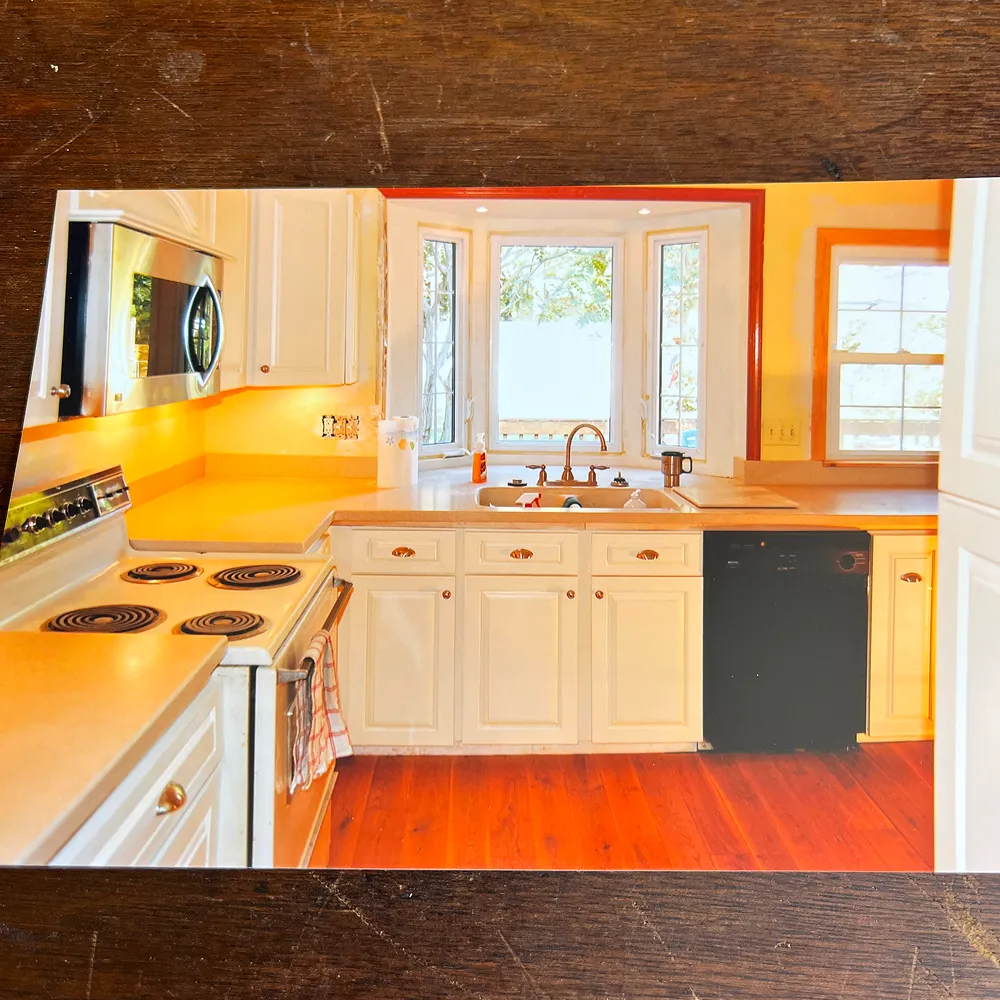 Bright kitchen with white cabinets and appliances.