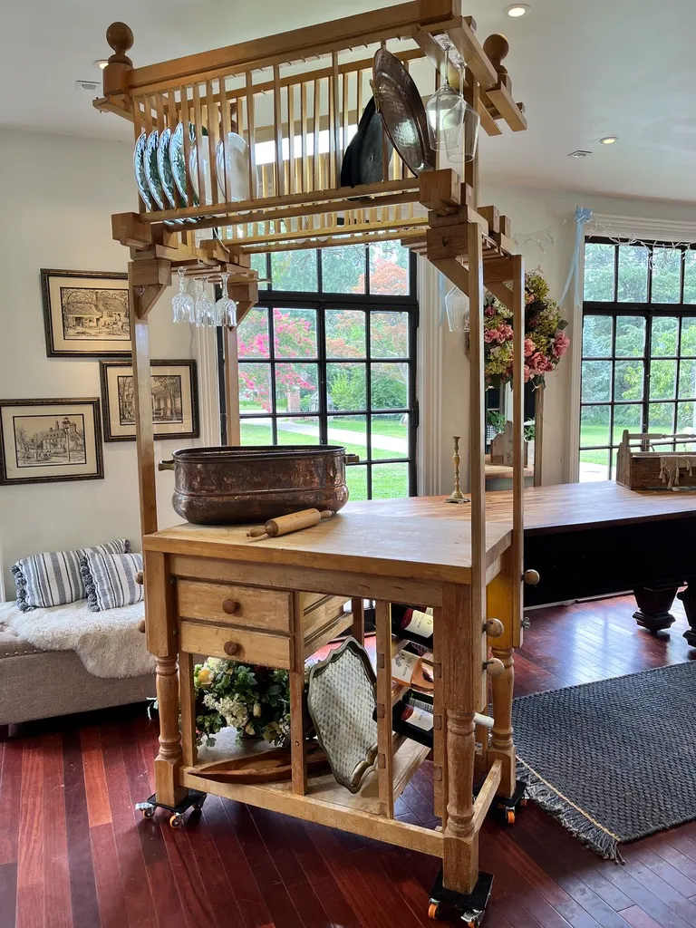 Wooden kitchen island with hanging dish rack.