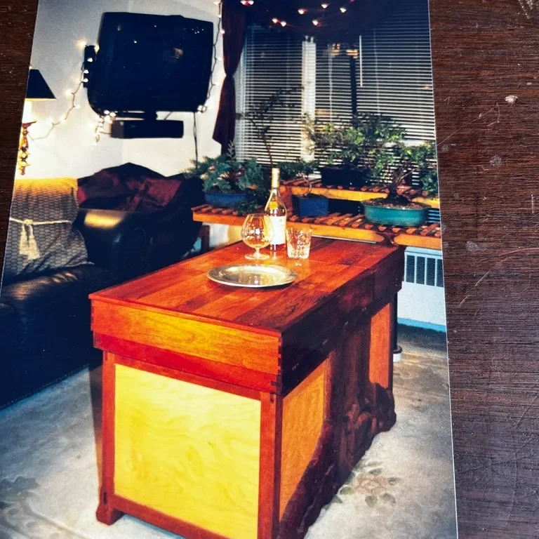 Wooden table with wine and glasses.